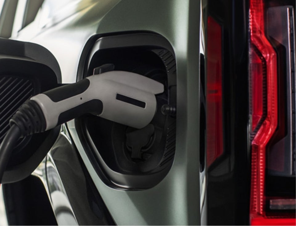 Close up of charging port with charger plugged in on a GMC Hummer EV SUV - Kramer GMC in LIVINGSTON TX